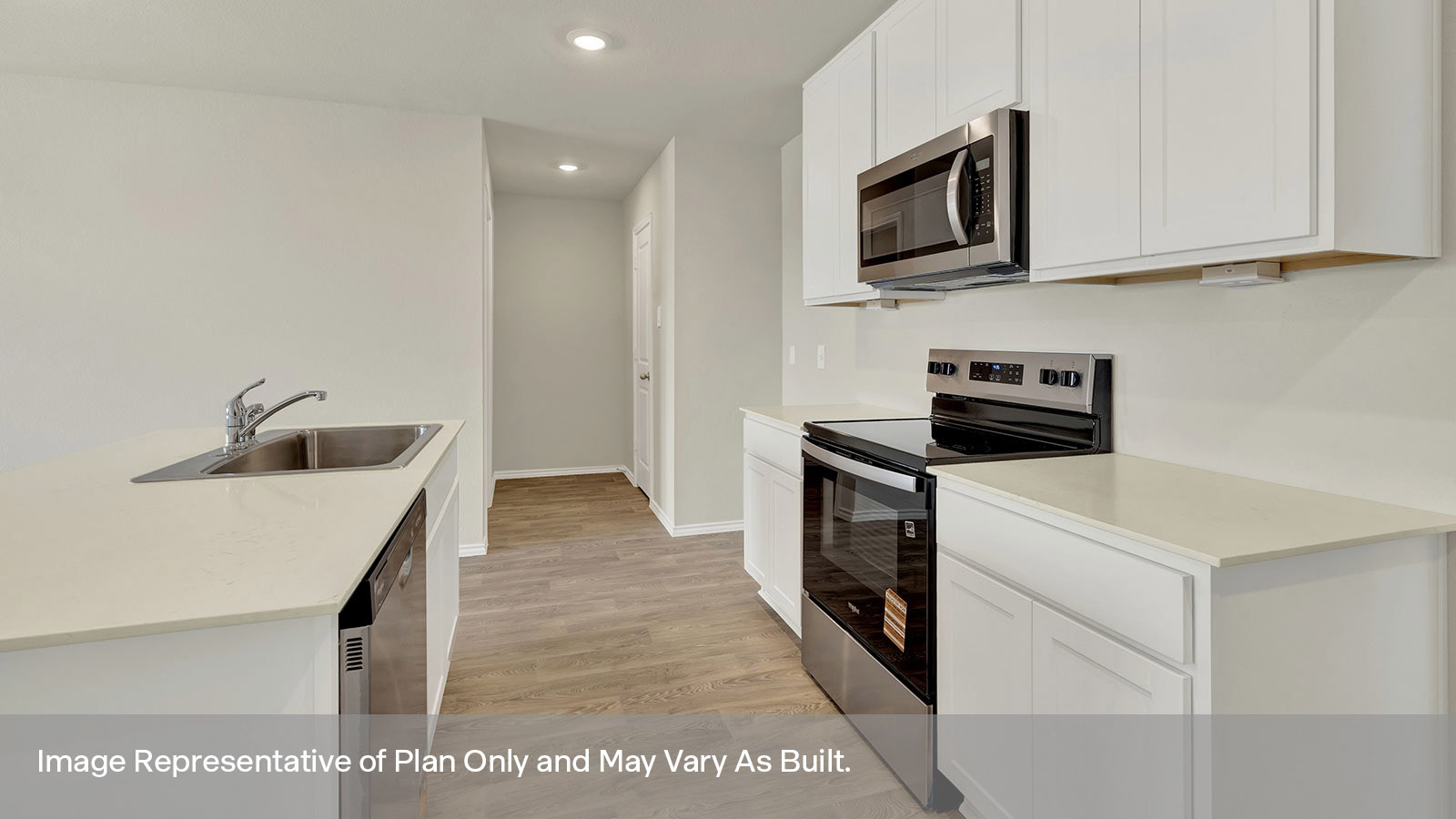 Kitchen with quartz countertops and stainless steel appliances.