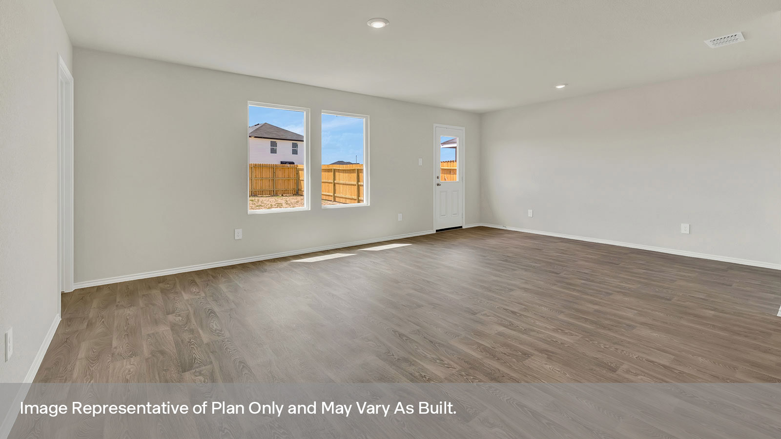 Living room with vinyl flooring, two windows, and a half lite exterior door.