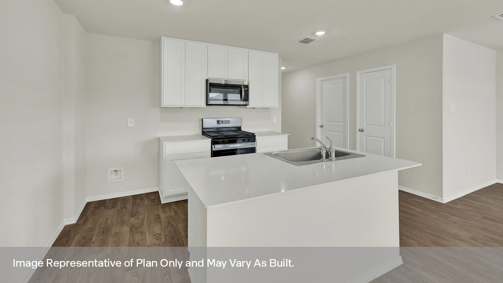 Kitchen with kitchen island and white cabinets.