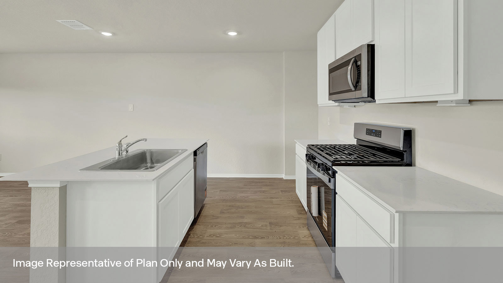 Kitchen with quartz countertops and stainless steel appliances.