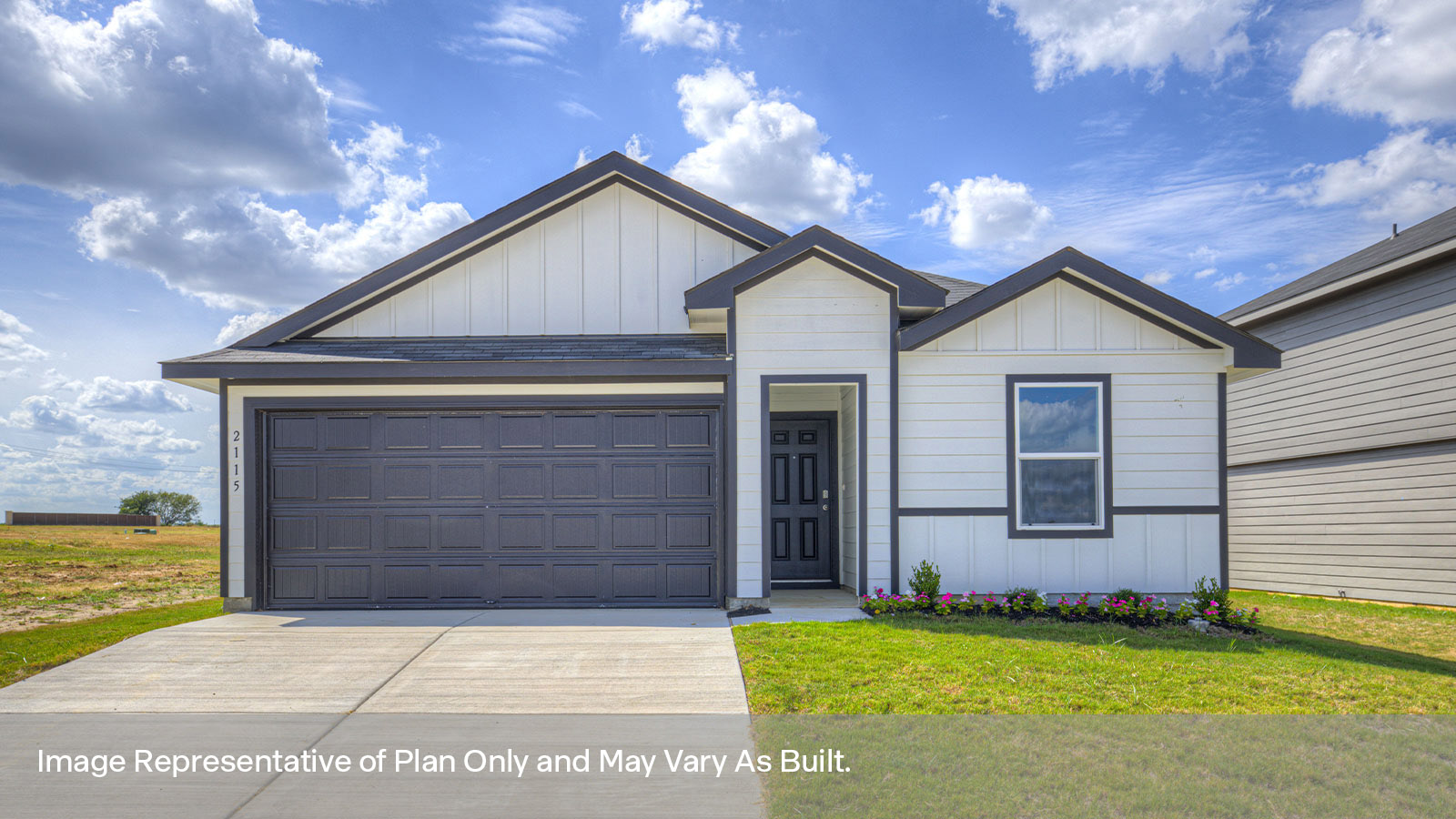 Single-story farmhouse exterior with one window and 2 car garage.