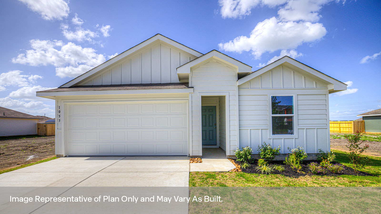 Single-story farmhouse exterior with one window and 2 car garage.