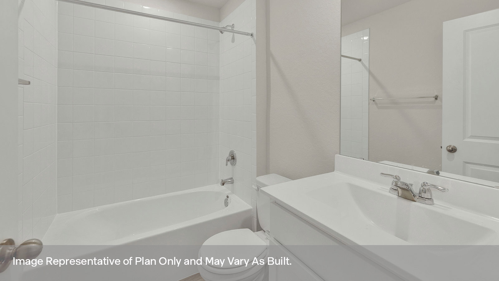 Hall bathroom with vanity, toilet, and tub with tile surround.