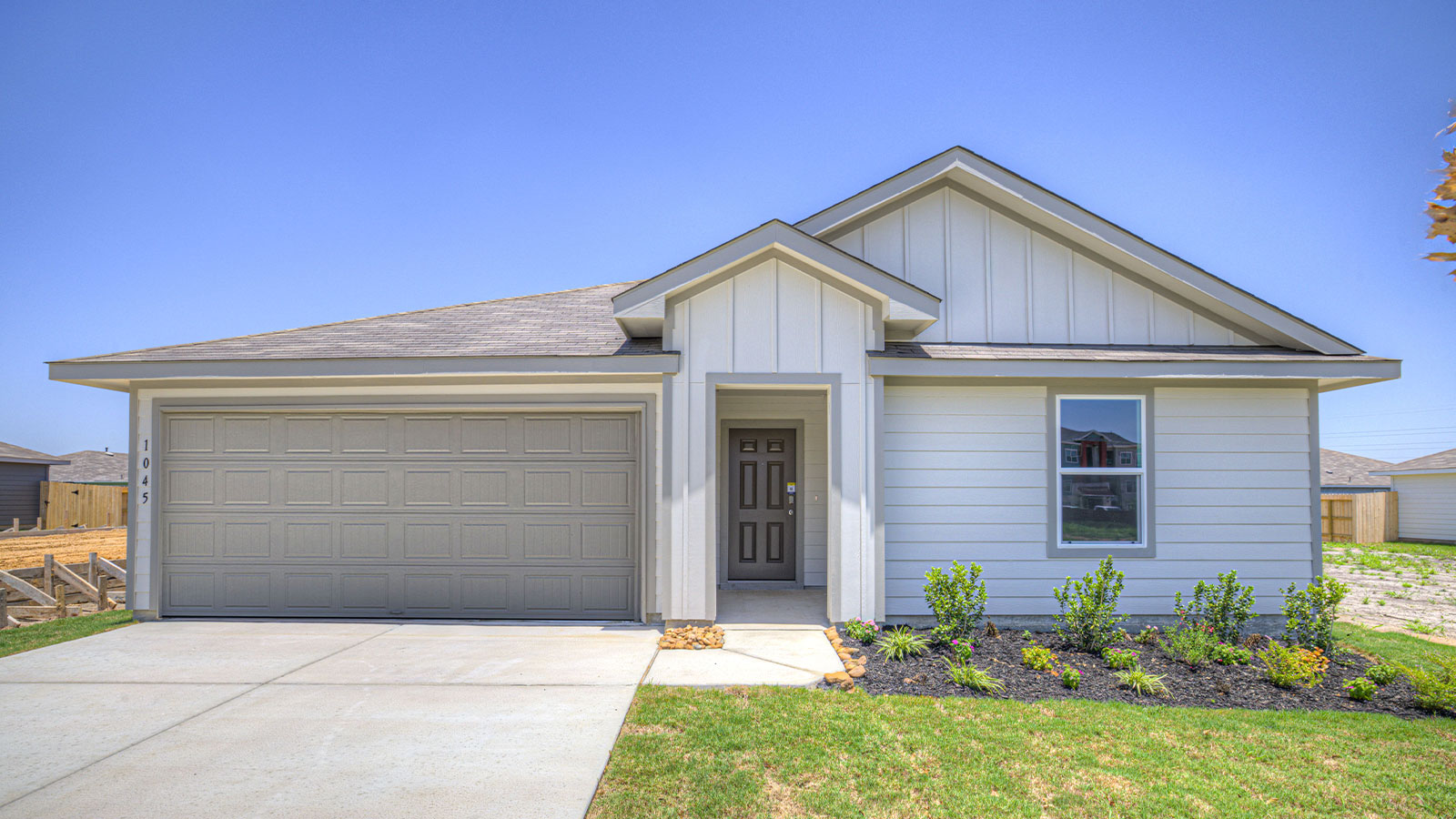 Single-story farmhouse exteriors with 2 car garage.
