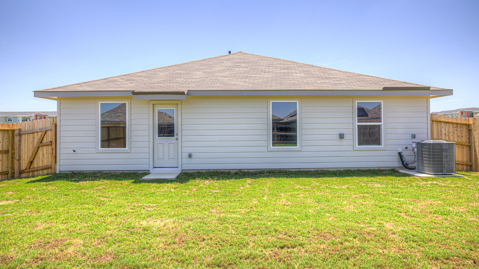 Backyard with fully sodded backyard and privacy fence.