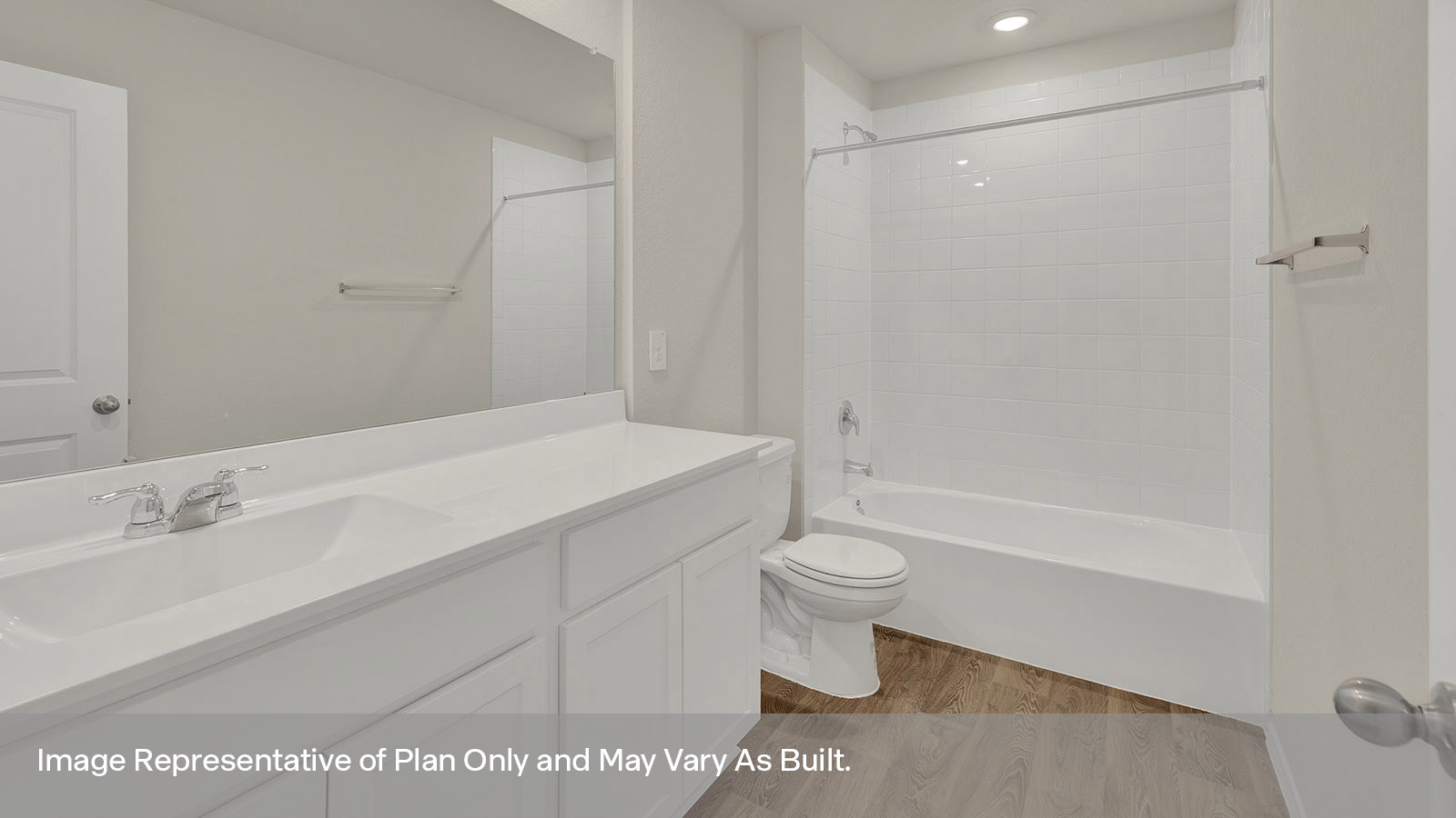 Hall bathroom with vanity, toilet, and tub with tile surround.