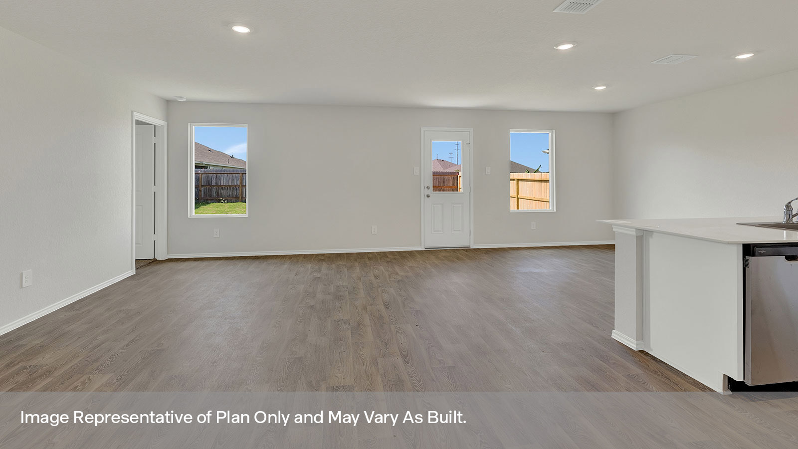 Living room with vinyl flooring, two windows, and a half lite exterior door.