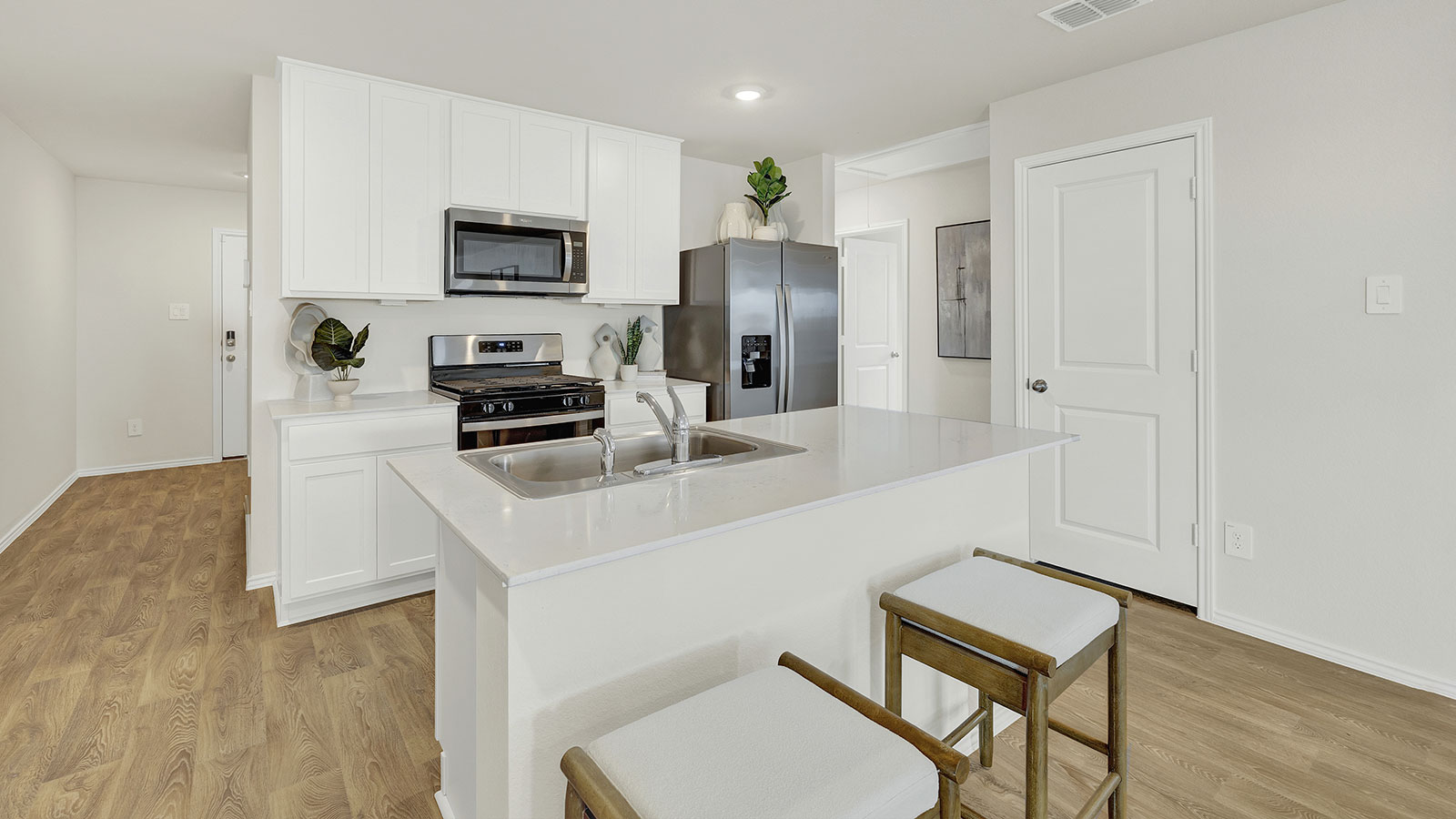 Kitchen with kitchen island and quartz countertops.