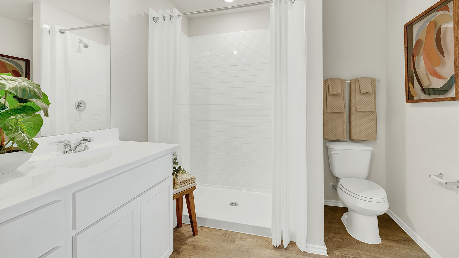 Main bathroom with vanity, toilet, and shower.