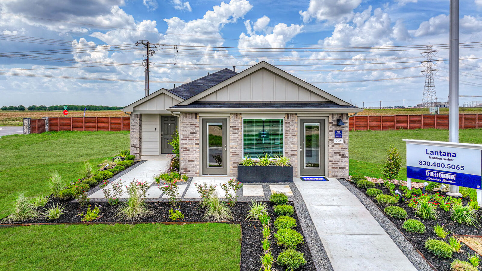 Single-story masonry exteriors with 2 car garage.