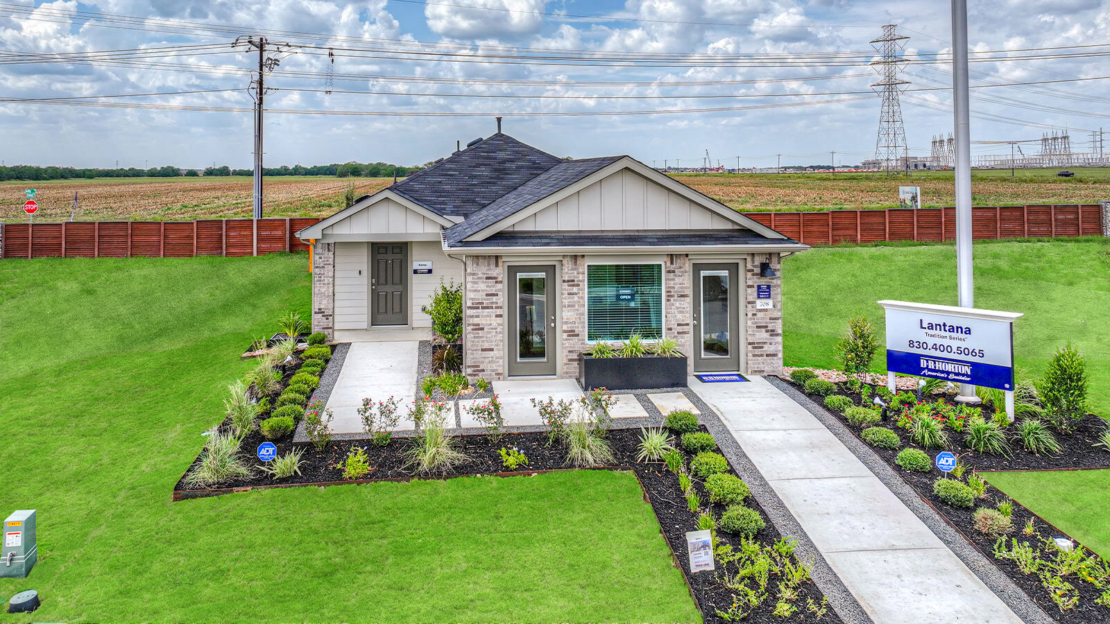 Single-story masonry exteriors with 2 car garage.
