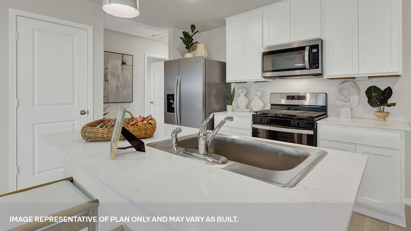Kitchen with quartz countertops and stainless-steel appliances.