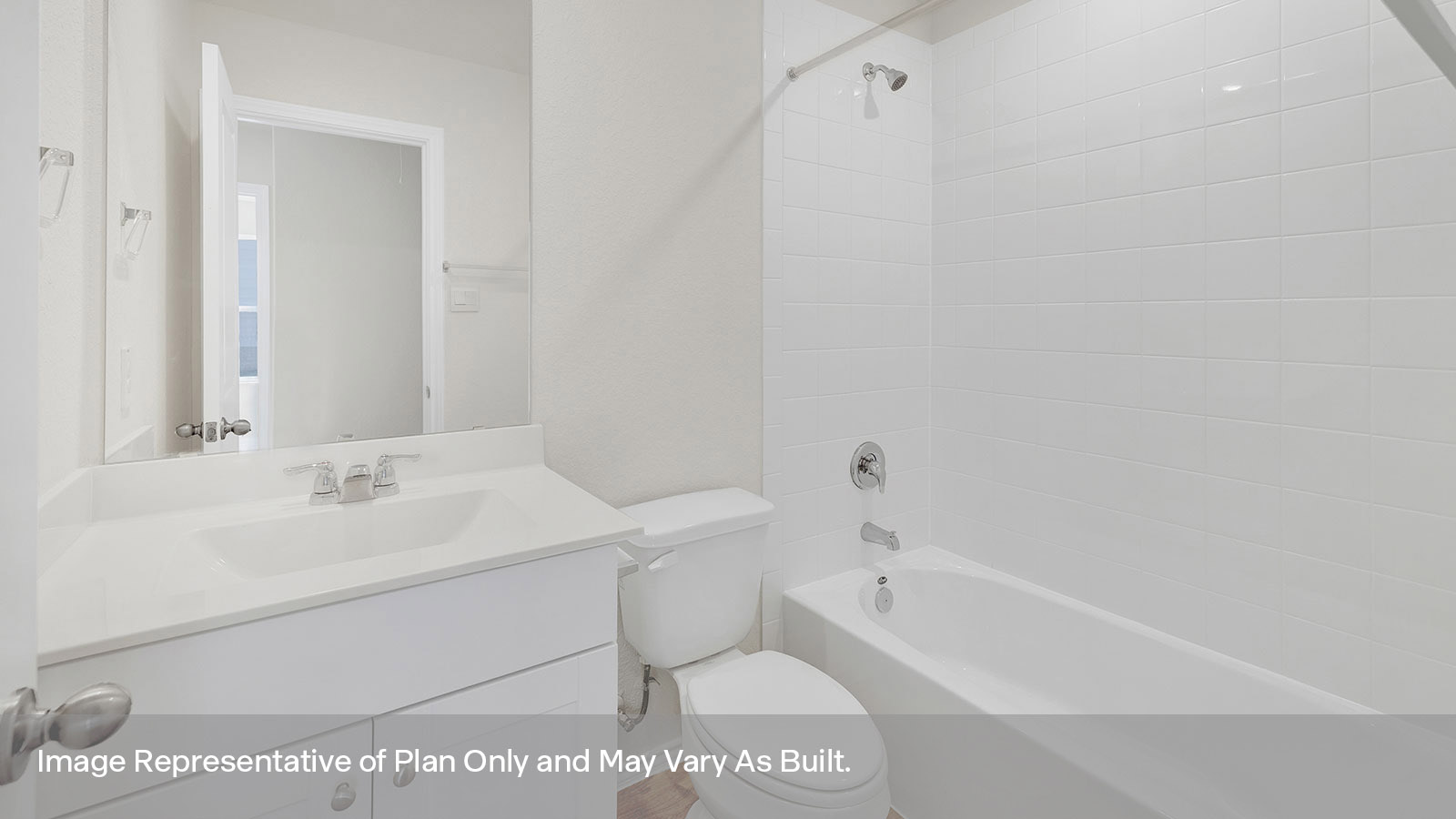 Hall bathroom with single-sink vanity, toilet, and tub with tile surround.