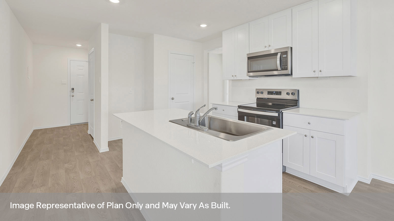 Kitchen with kitchen island and entry hallway.