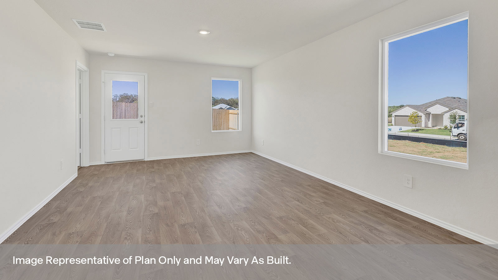 Living room with vinyl flooring, 2 windows, and a half lite exterior door.