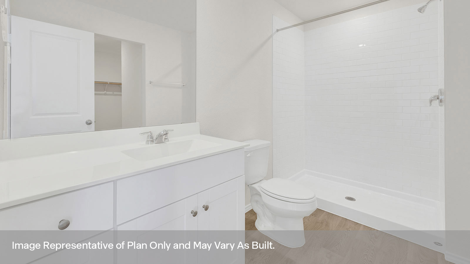 Main bathroom with vanity, toilet, and tiled shower.
