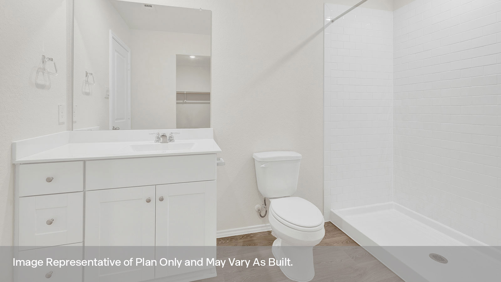 Main bathroom with vanity, toilet, and tiled shower.
