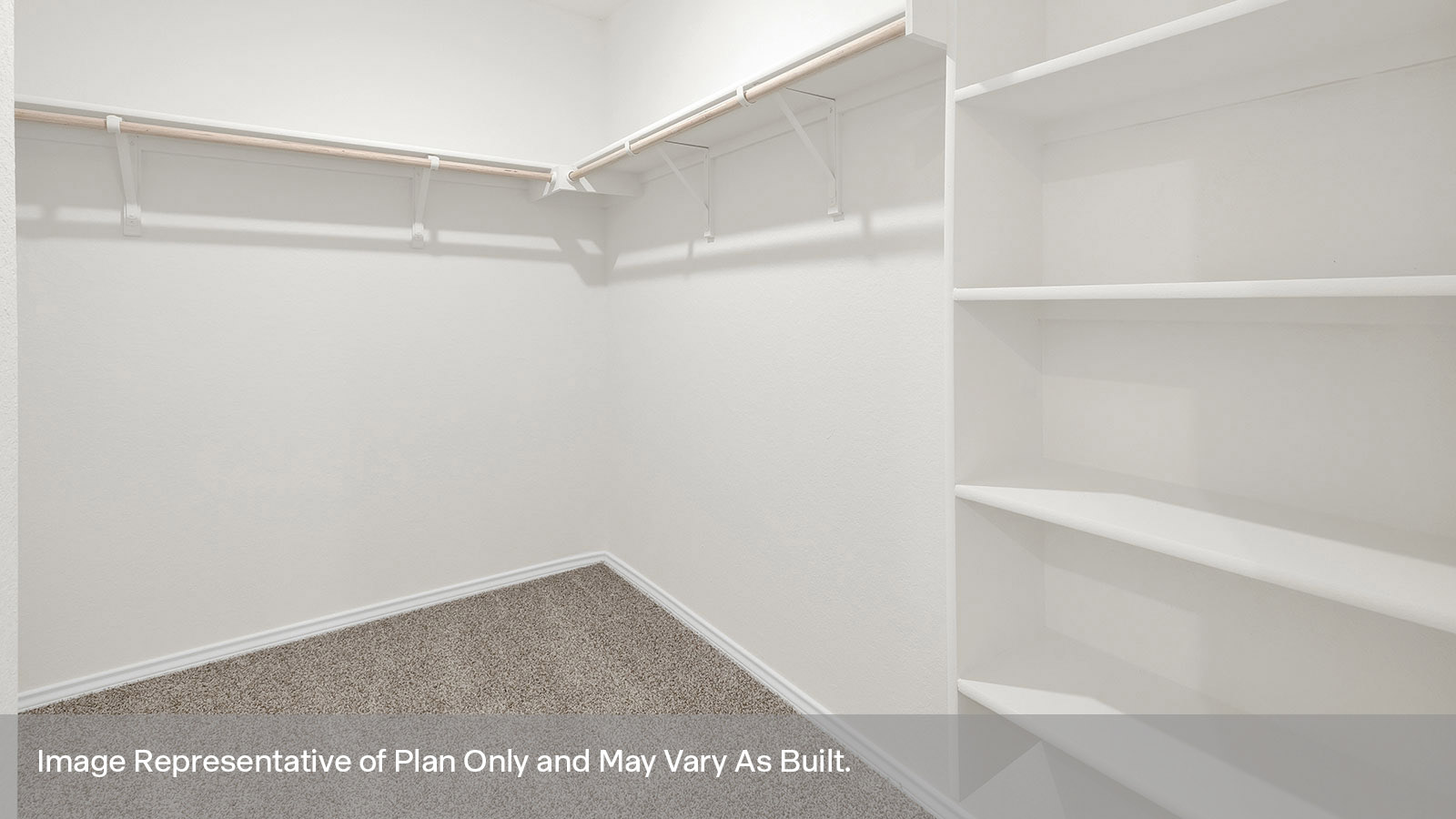 Main bedroom closet with carpeting and wooden shelving.