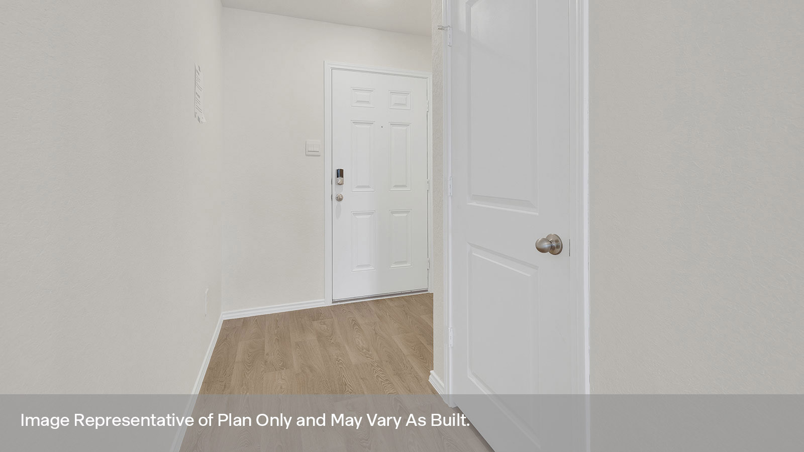 Entryway with vinyl flooring and front door.
