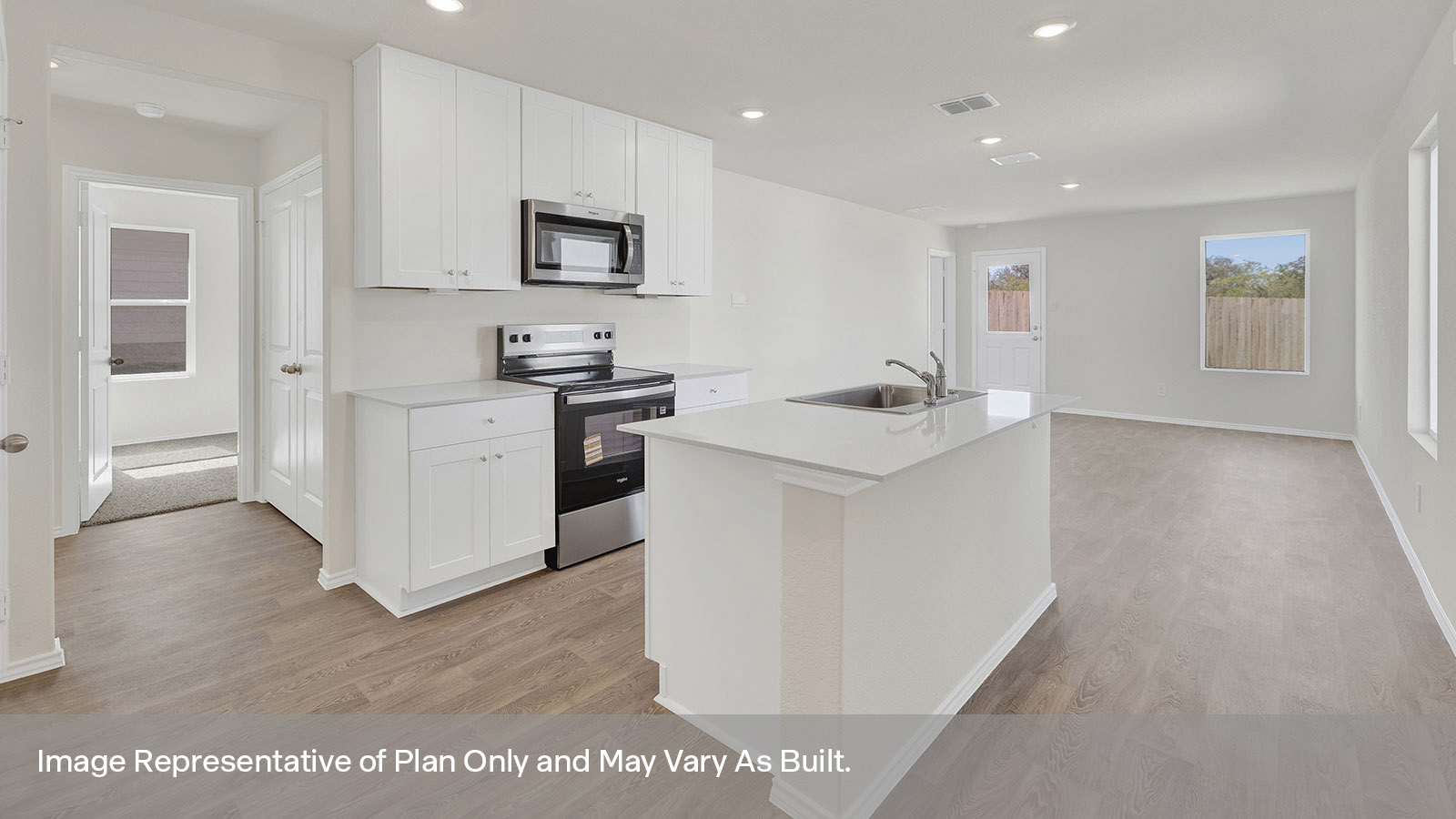 Kitchen with kitchen island and entry hallway.