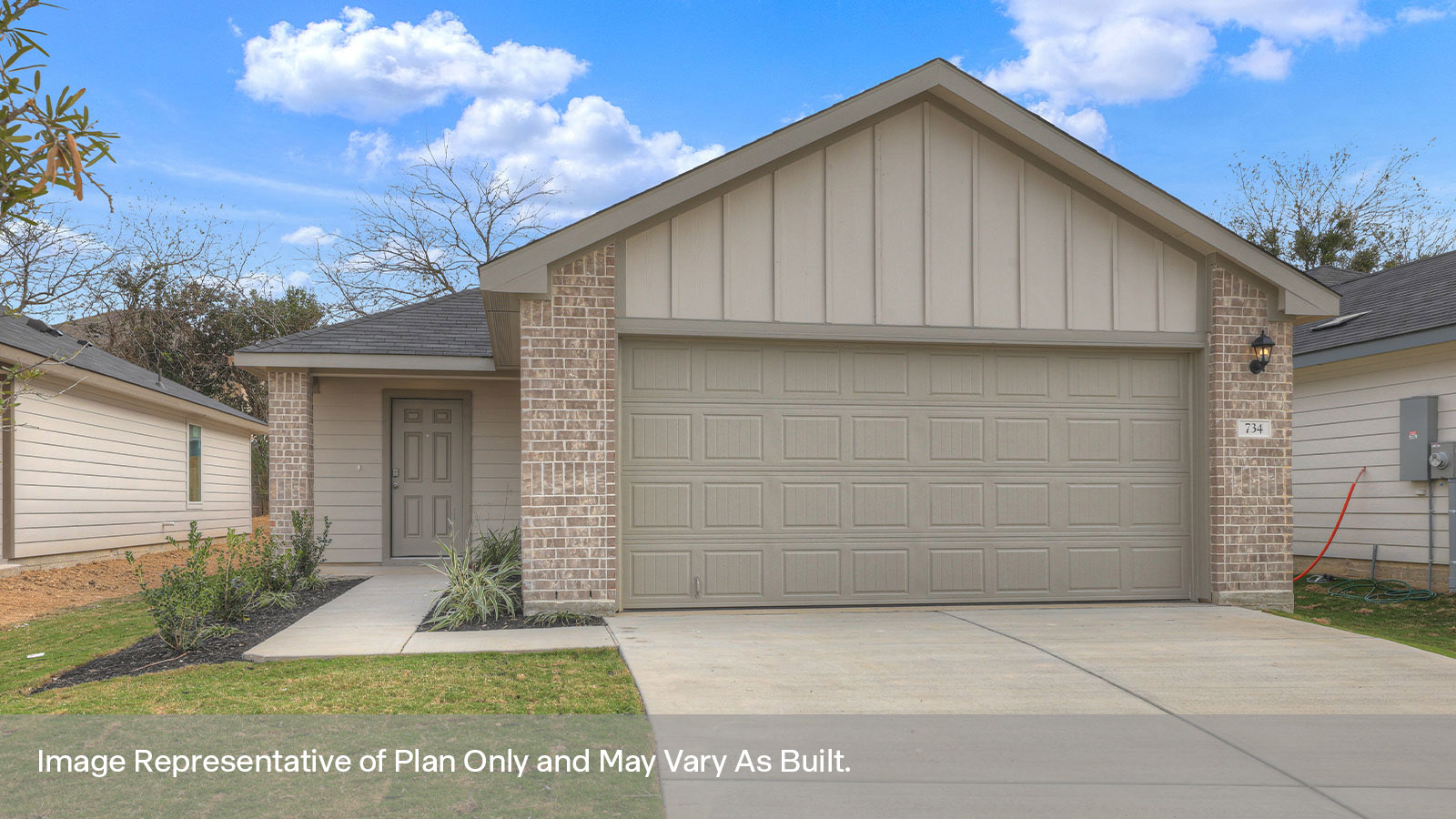 Single-story farmhouse with 2 car garage.