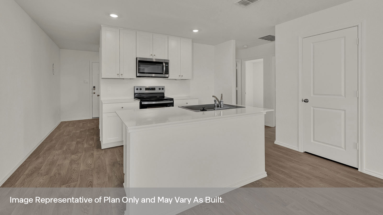 Entry hallway leading to the kitchen with kitchen island.