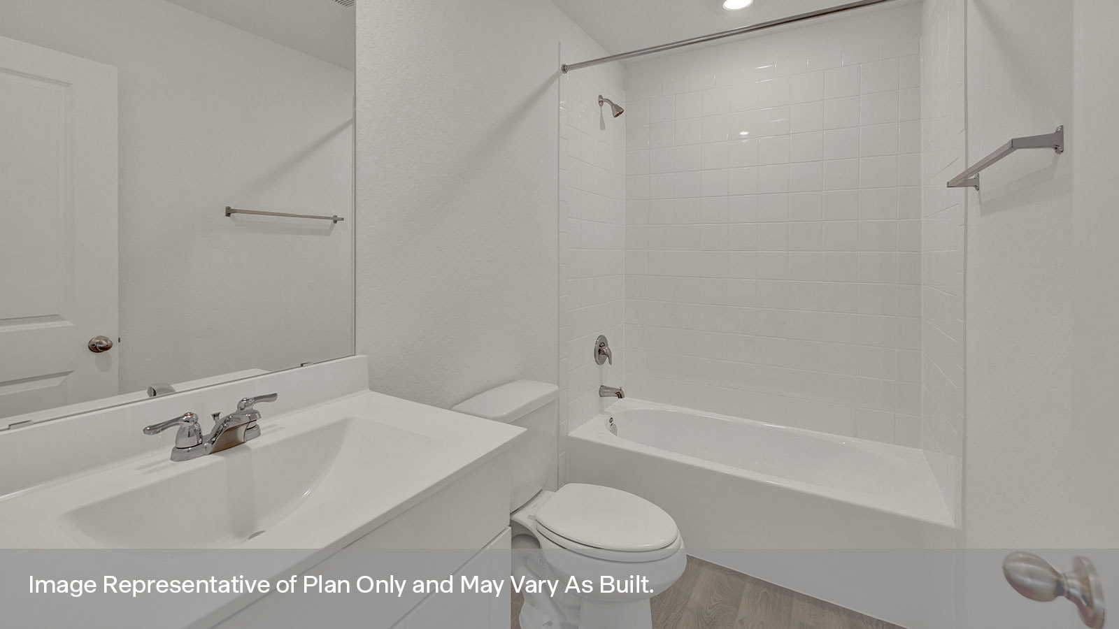 Hall bathroom with vanity, toilet, and tub with tile surround.