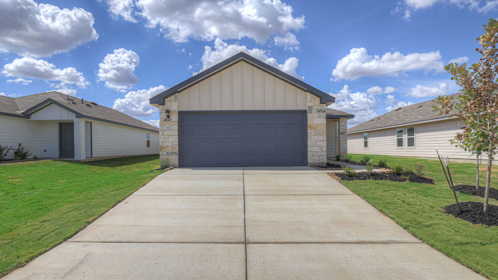 Single-story farmhouse with 2 car garage.