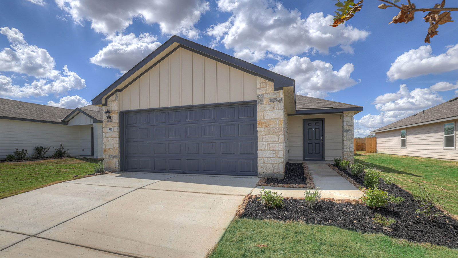 Single-story farmhouse with 2 car garage.