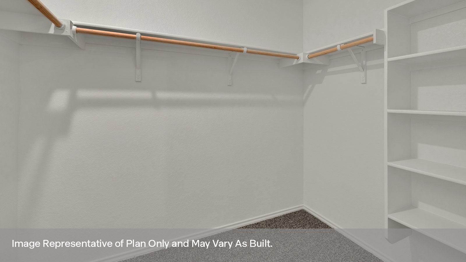 Main bedroom closet with carpeting and wooden shelving.
