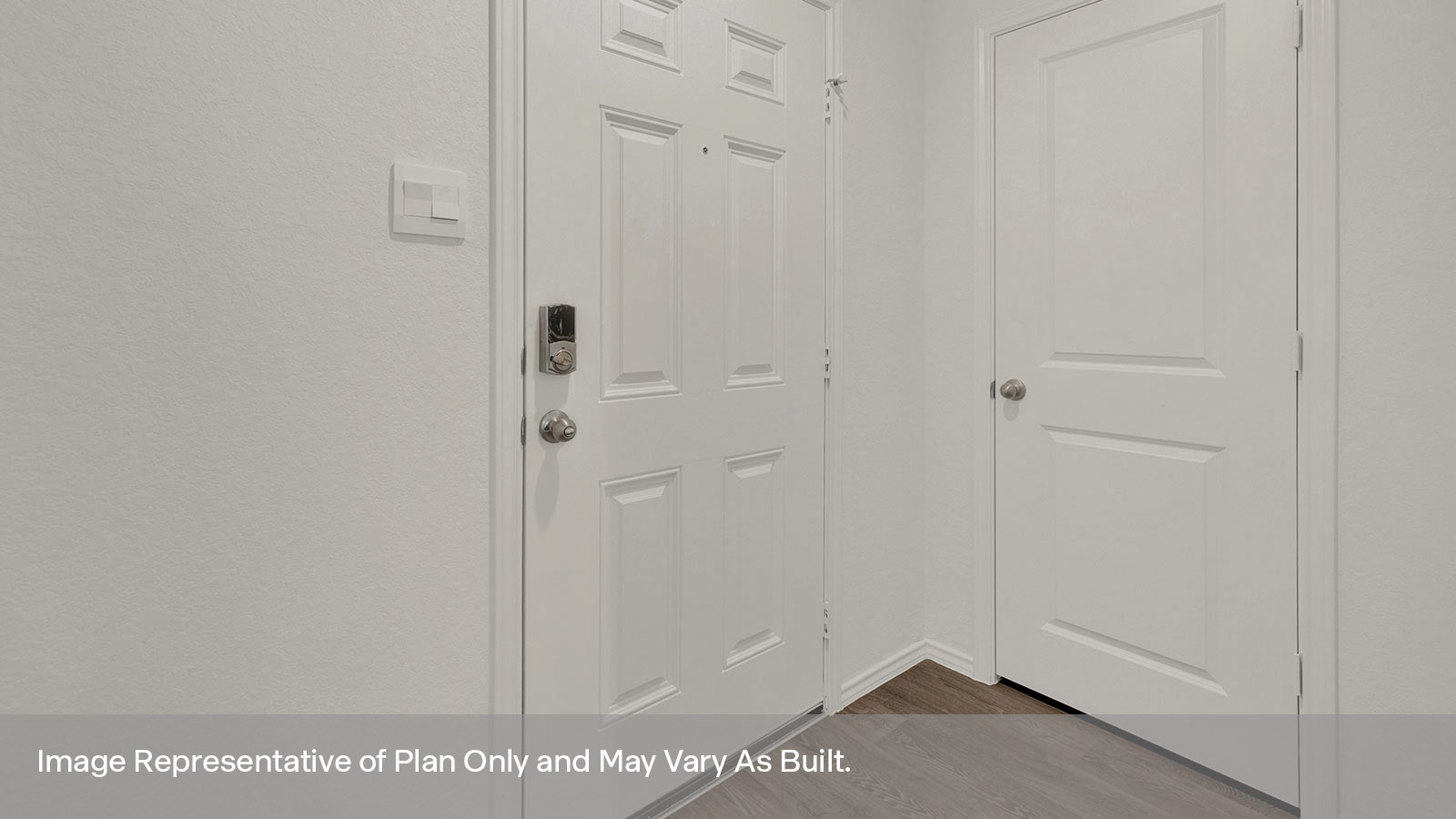 Entryway with vinyl flooring and front door.