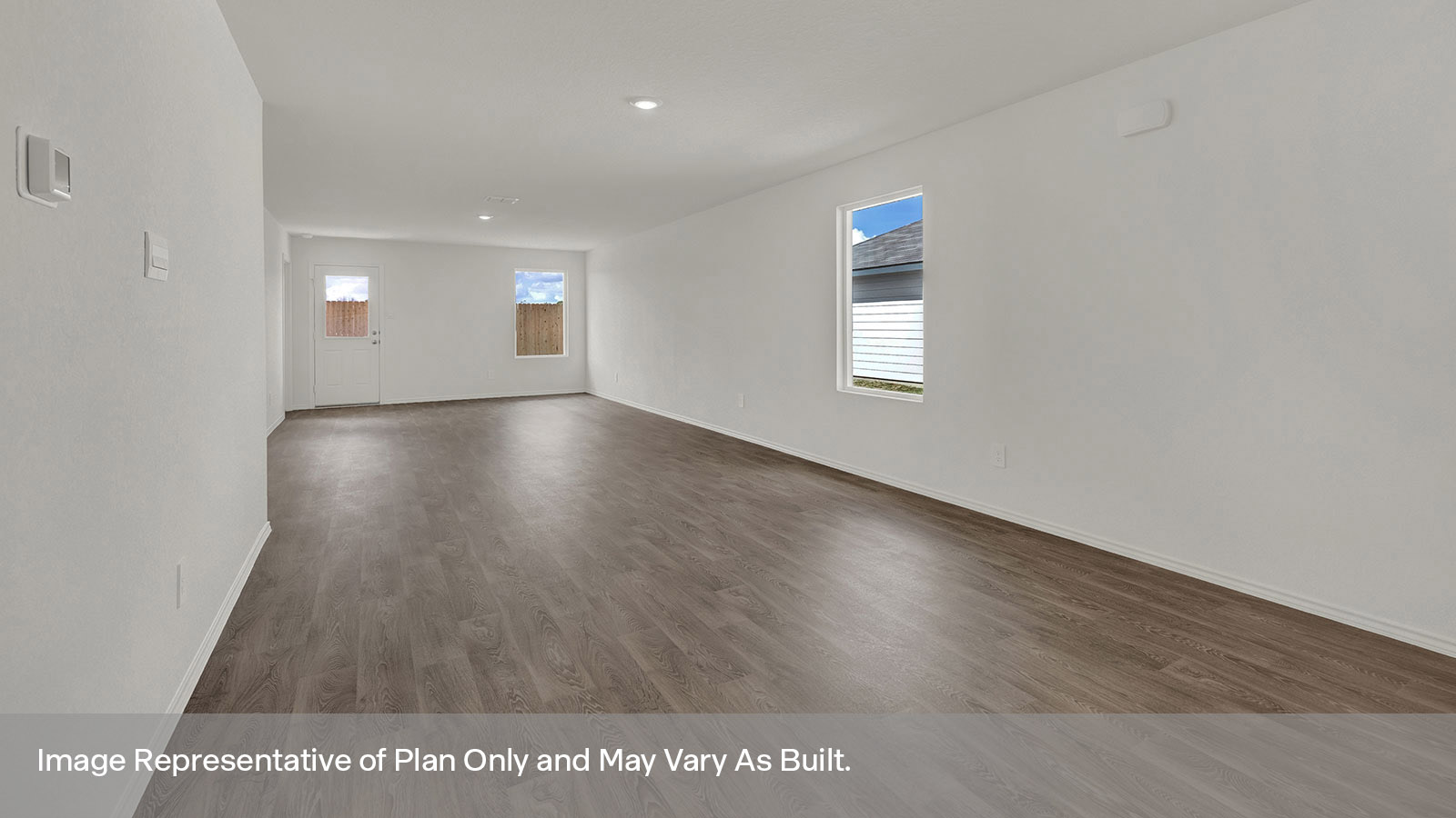 Dining room with vinyl flooring and opening to the living room.