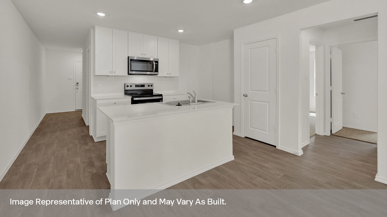 Kitchen with kitchen island and entry hallway.