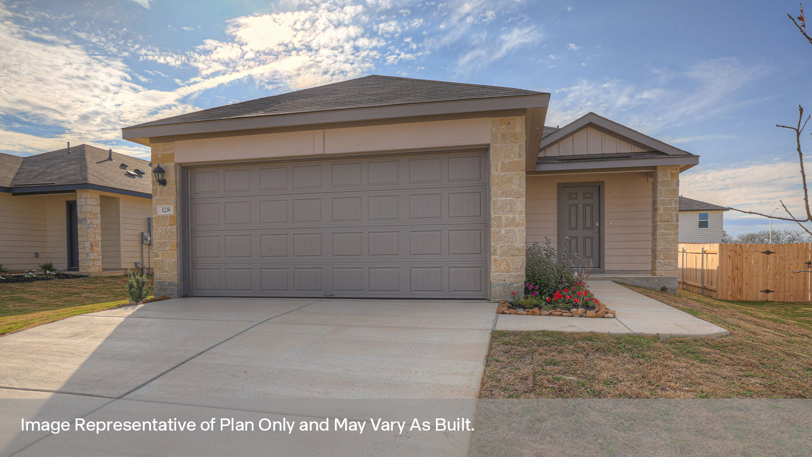 Two car garage, siding and a wrap around sidewalk to the front entry