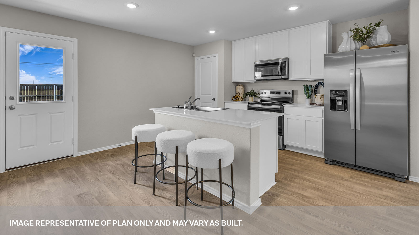 Kitchen with kitchen island and white cabinets.