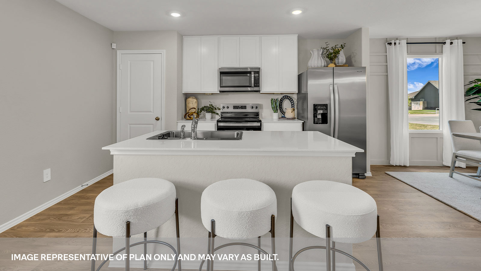 Kitchen with kitchen island and white cabinets.