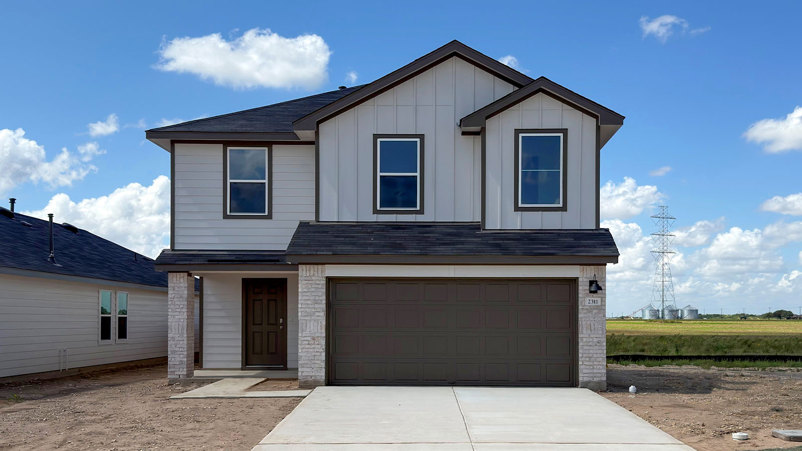 2-story home with a two car garage and masonry exterior