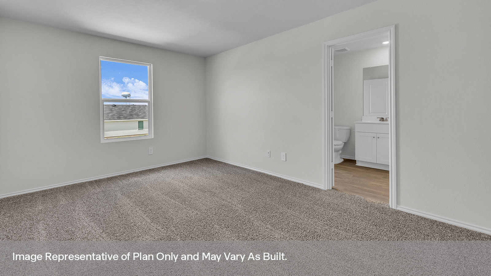 Primary bedroom with carpeting, a window and entry into the onsuite bathroom