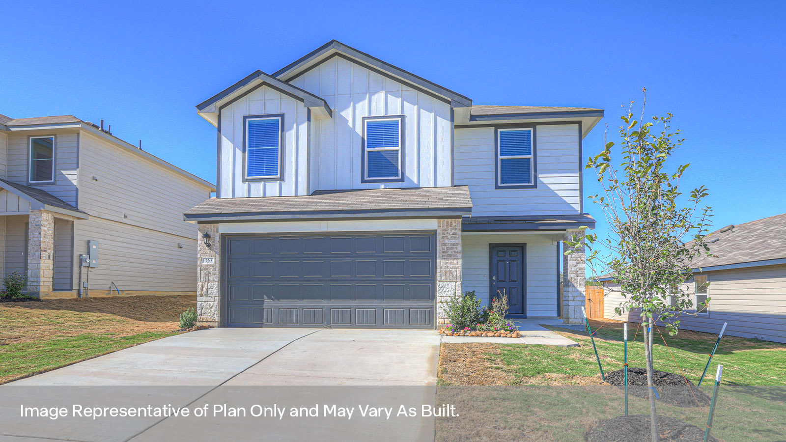 2-story home with a two car garage and masonry exterior