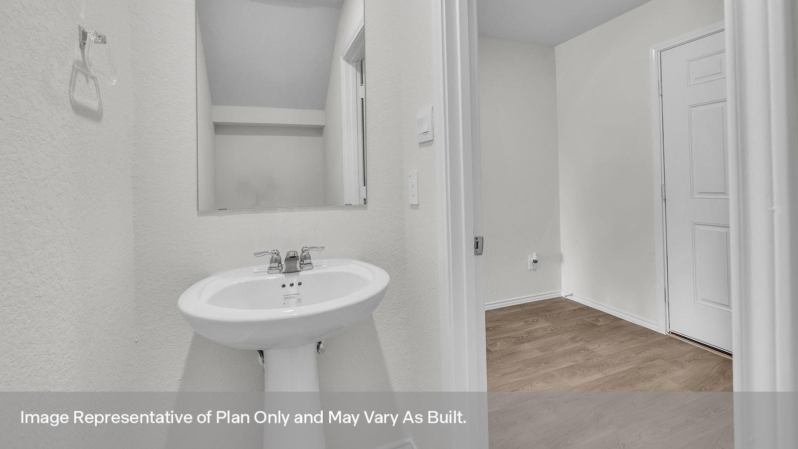 Powder room featuring a pedestal sink and toilet