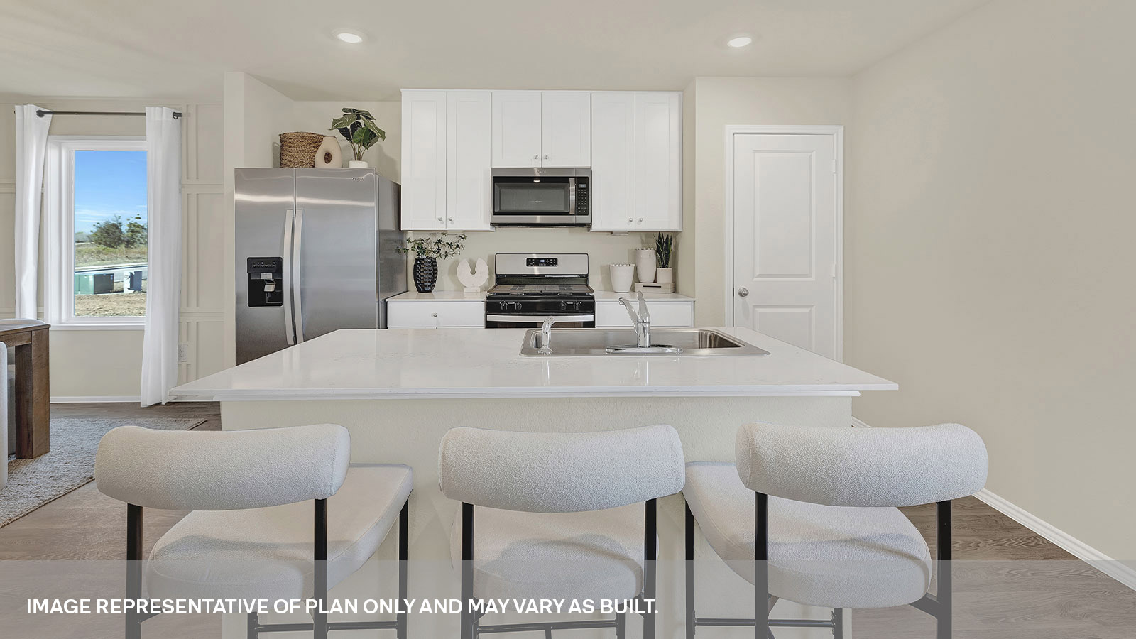 Kitchen island with quartz countertops and stainless steel appliances.