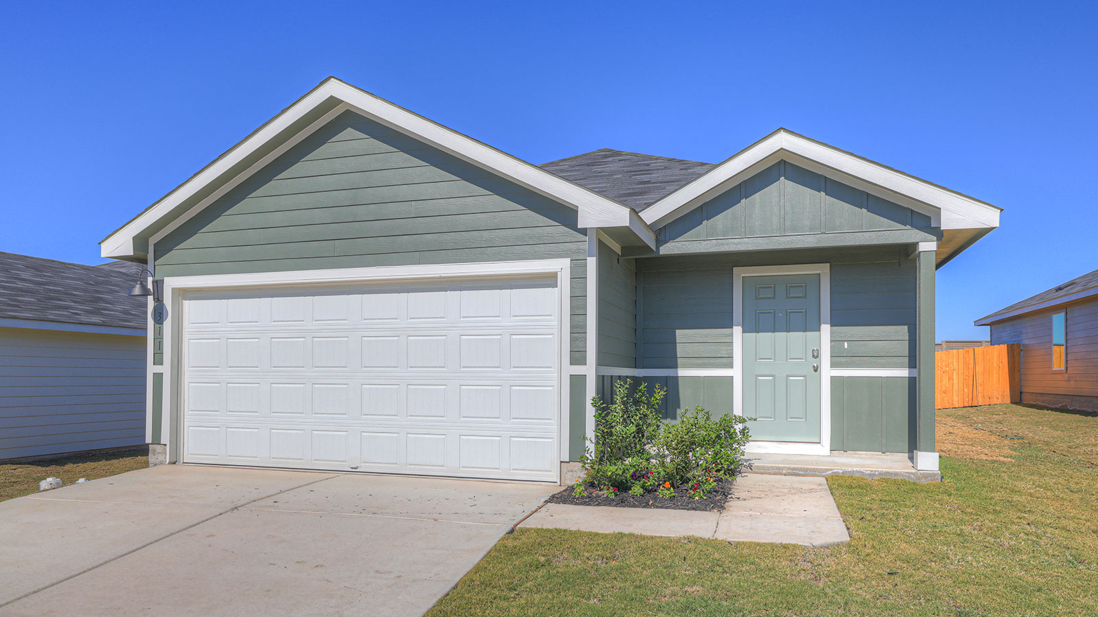 Single-story farmhouse with 2 car garage.