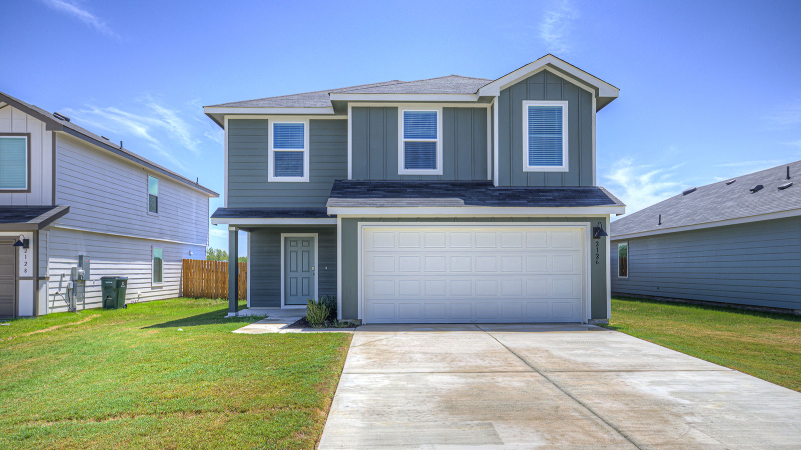 Two-story farmhouse exterior photo with 2 car garage.