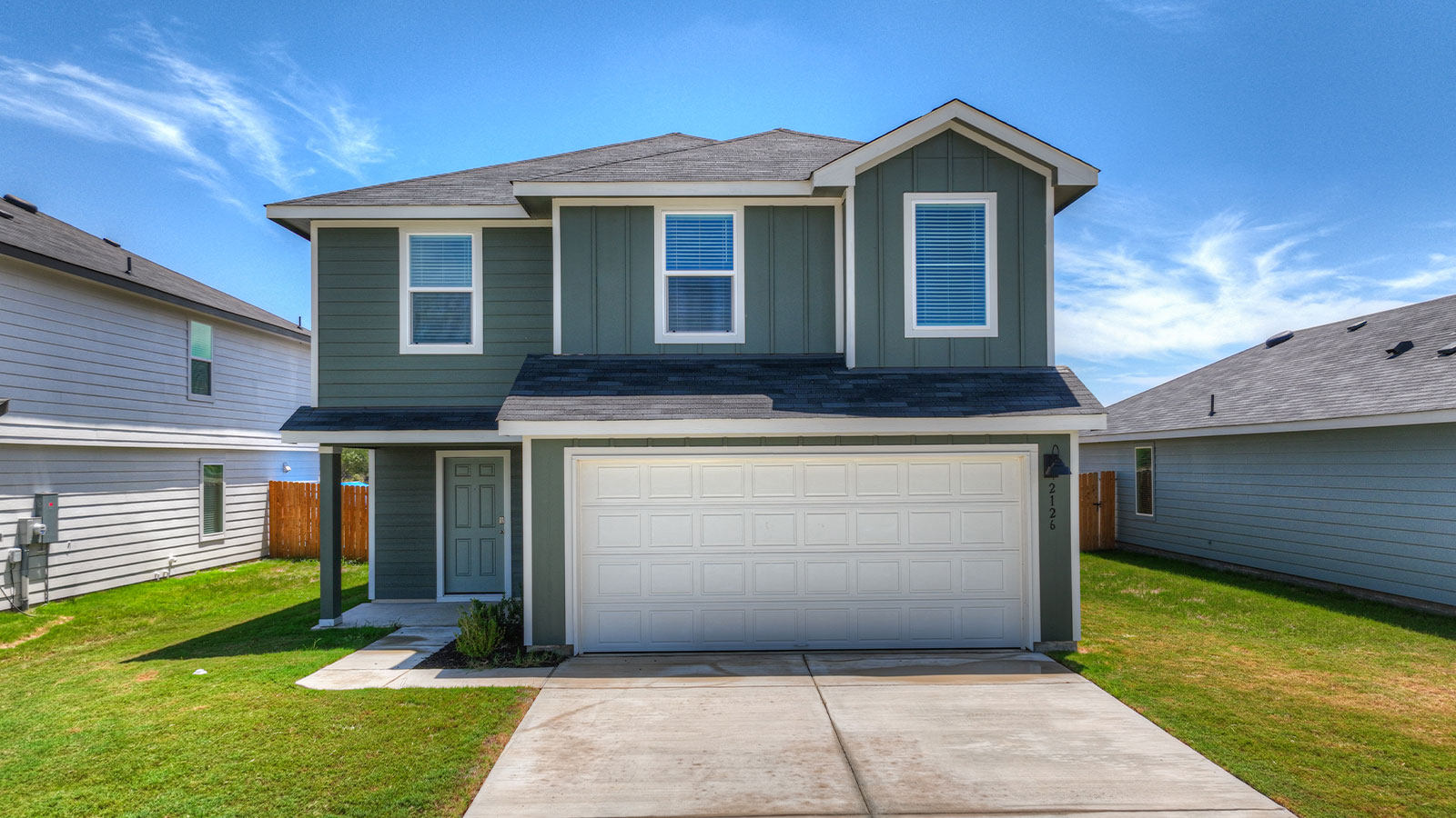 Two-story farmhouse exterior photo with 2 car garage.