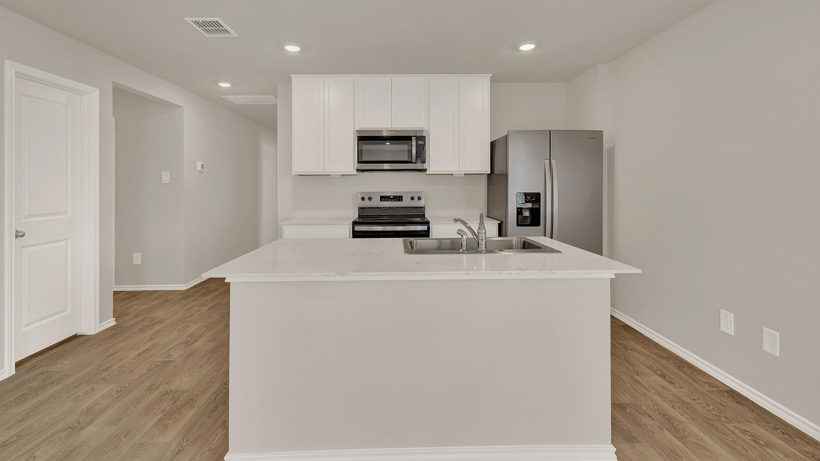 Kitchen with kitchen island with white cabinets and kitchen island.