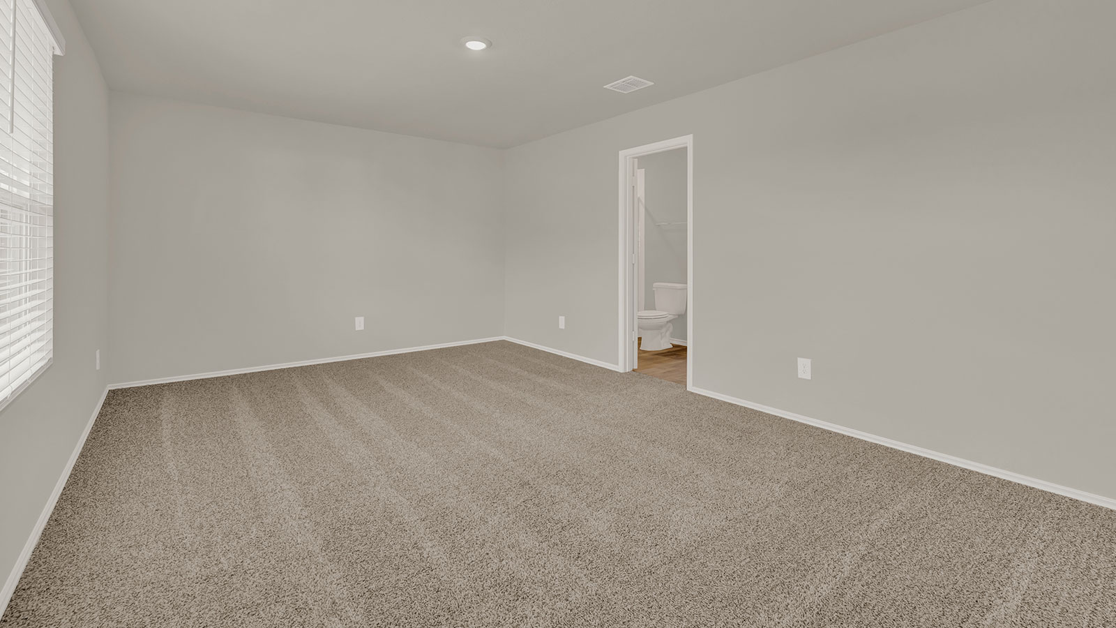 Main bedroom with carpeting.