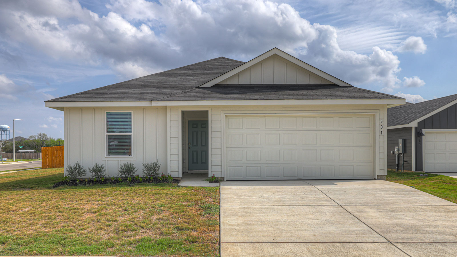 Single-story farmhouse with 2 car garage.