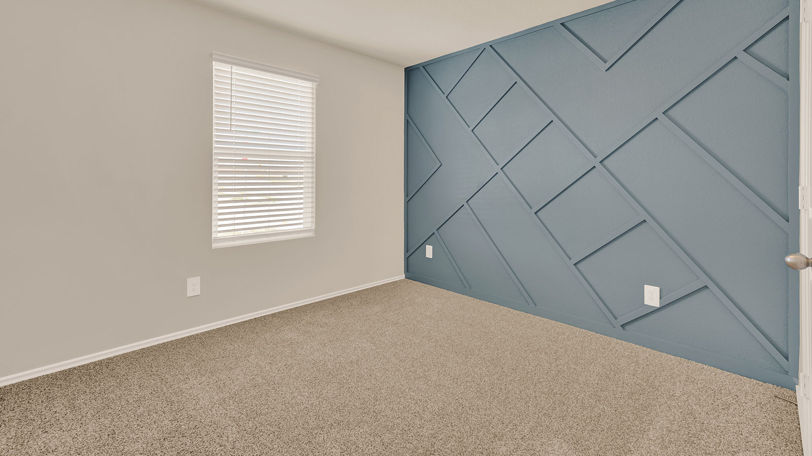 Front bedroom with carpeting and one window.