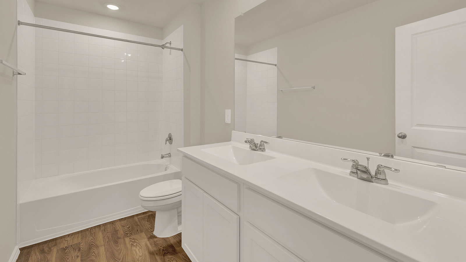 Hall bathroom with tub with tile surround, toilet, and single-vanity sink.