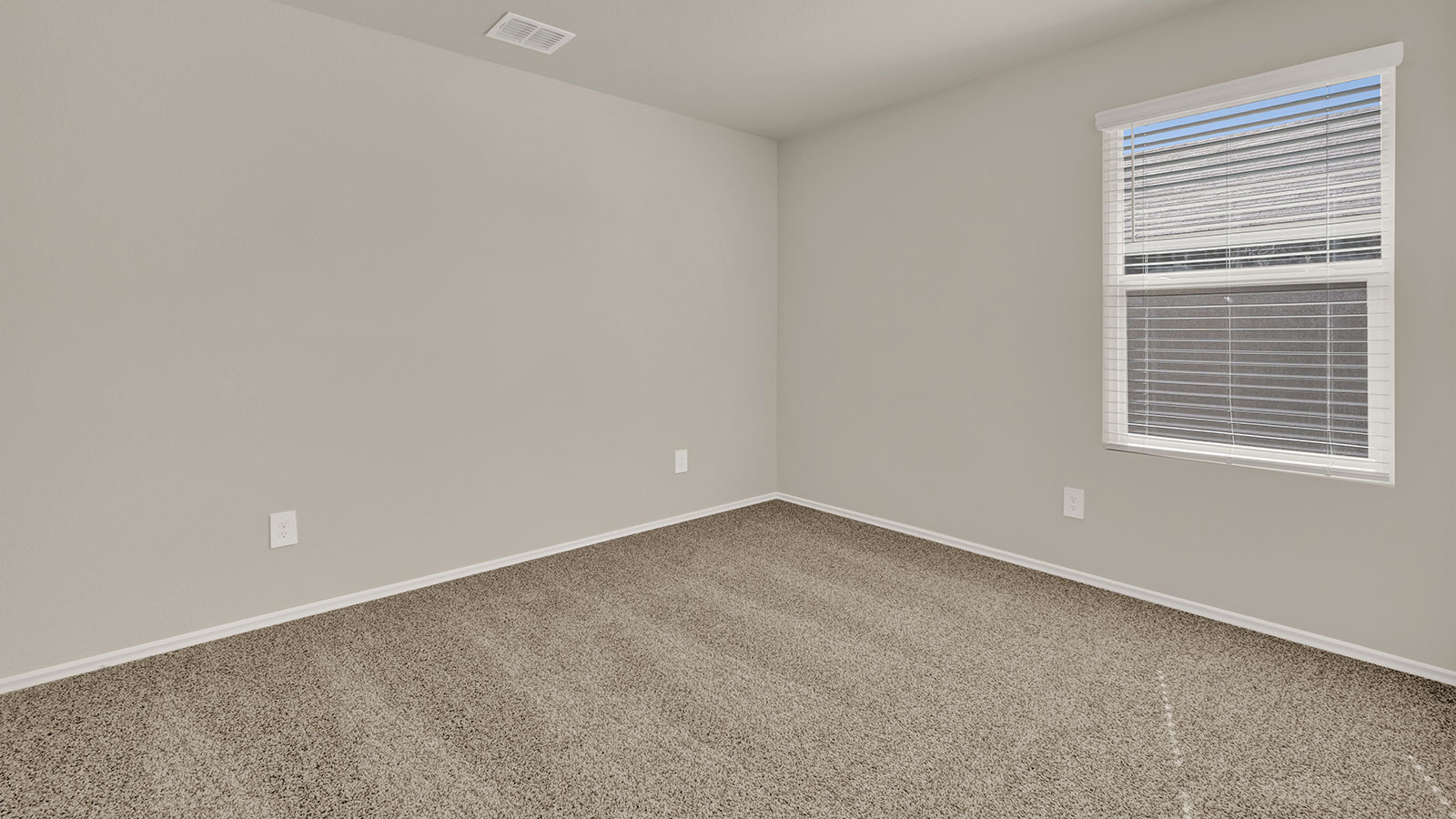 Secondary bedroom with carpeting and one window.